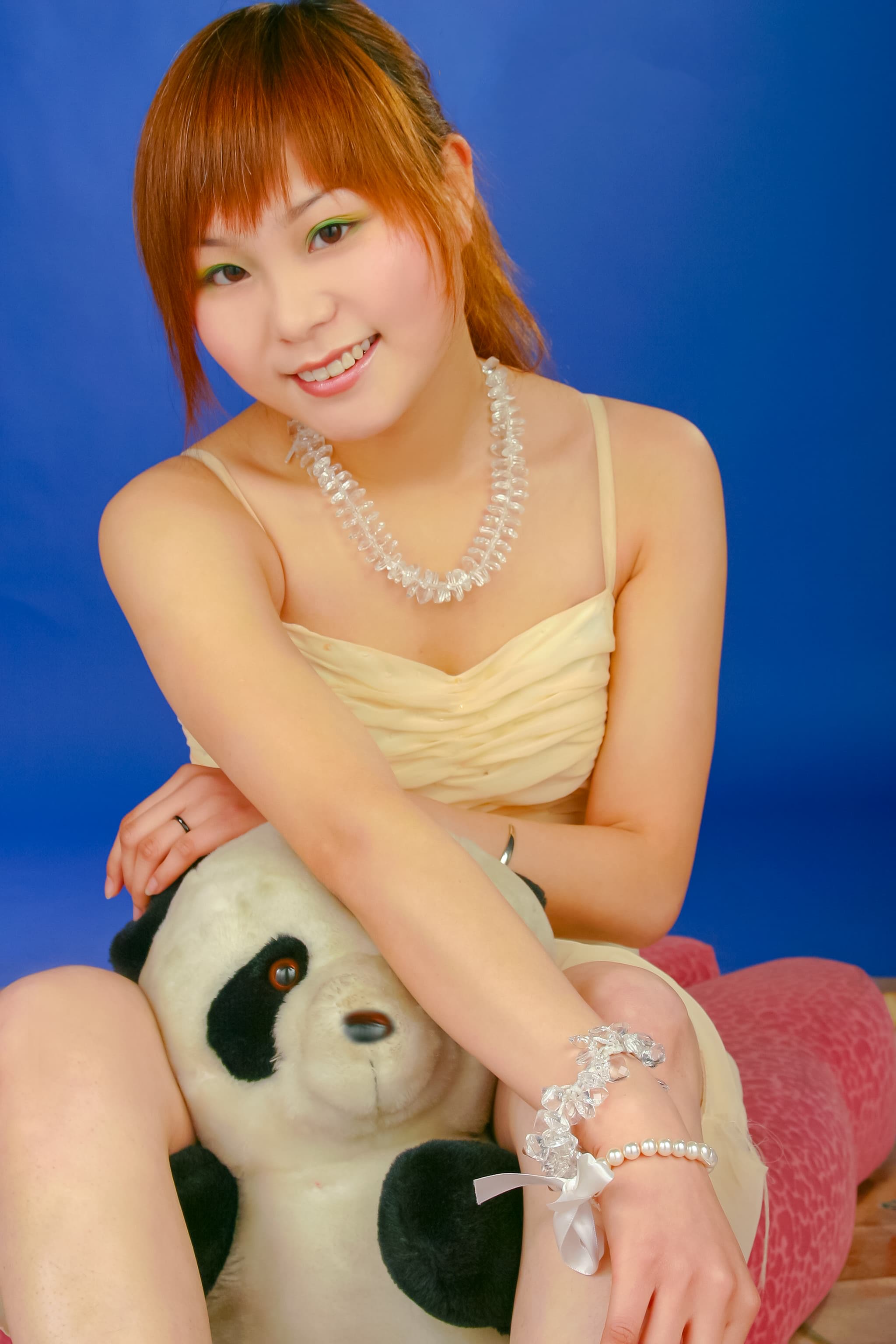 Xiaoxi in strapless dress showing legs